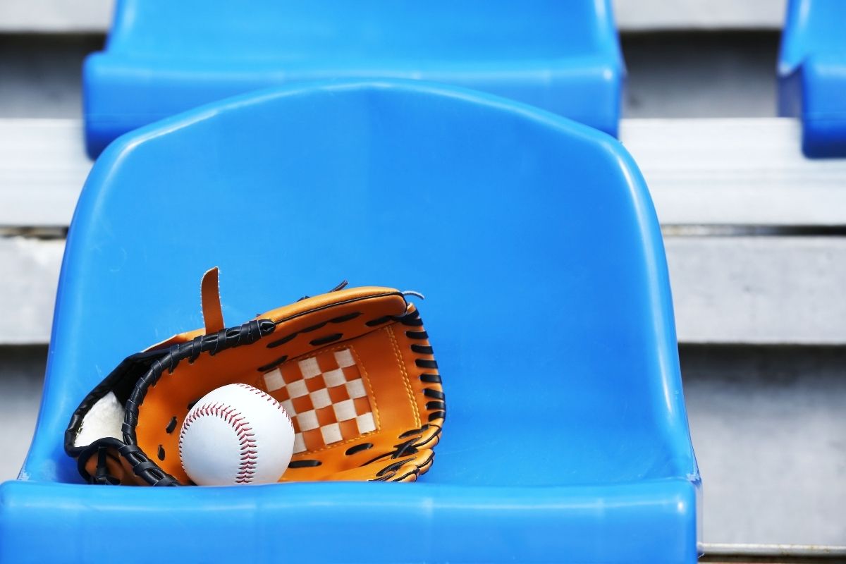 Baseball Ball and Glove on Stadium Seat